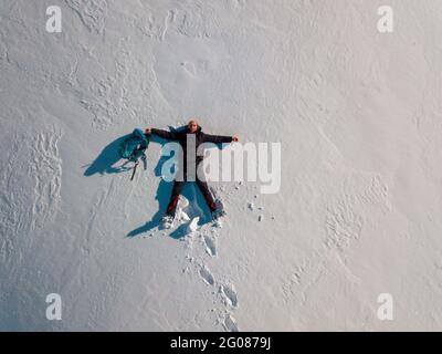 Overhead view of man lying in snow Stock Photo