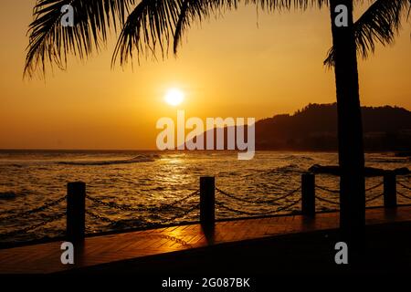 Amazing view of sunset over sea on asian island. Stock Photo