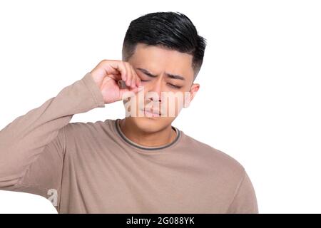 Tired Young man  rubbing   eyes .stress and frustration concept. Stock Photo