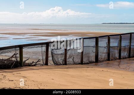 Part of a netted safe swimming enclosure on a beach with the tide out Stock Photo