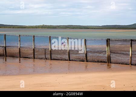 Part of a netted safe swimming enclosure on a beach with the tide out Stock Photo