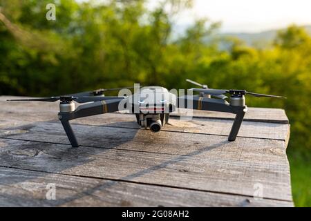 DJI Mavic pro drone with eyes and teeth on a wooden table Stock Photo