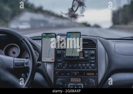 Car interior with the phones used as navigation devices Stock Photo