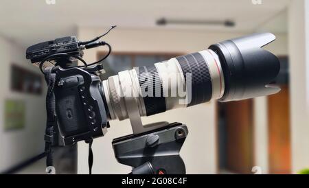 close up of camera with lens on tripod Stock Photo