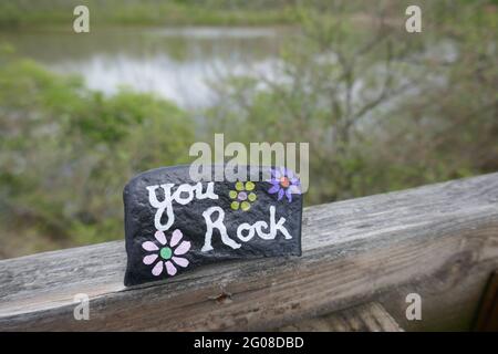 Close-up of You Rock message painted on kindness rock Stock Photo