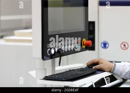 Engineer using industrial computer in modern factory. Selective focus. Stock Photo