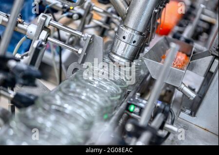 Machine for filling red caviar into glass jars. Filling equipment, food industry Stock Photo