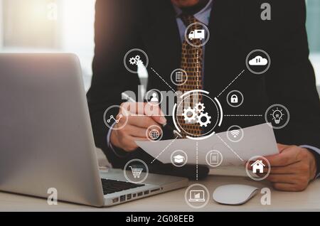 Digital Marketing Male Businessman holding business documents finance and analysis or reports. networking connection on virtual screen, Business techn Stock Photo