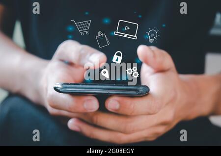 man touching smart phone business icon, Marketing and shopping social online network connection on modern virtual interface. Stock Photo