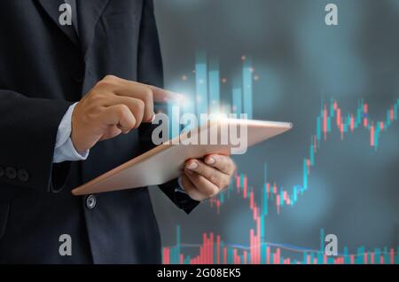 Businessman holding tablet and graph. Financial investment business and funds or stocks. Digital marketing networking connection on virtual screen, Bu Stock Photo