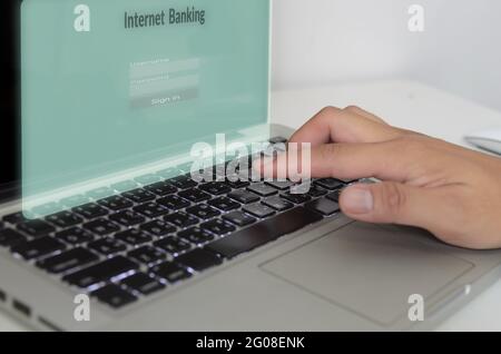 hand is typing the computer keyboard on virtual screen internet banking.Business finance technology concept Stock Photo