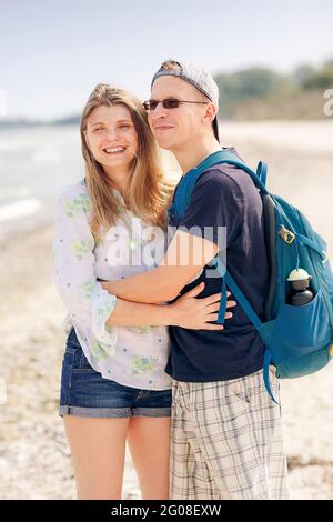 Portrait of a cheerful couple hugging on beach Stock Photo