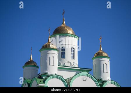 Orthodox crosses on gold domes againts blue sky. Stock Photo