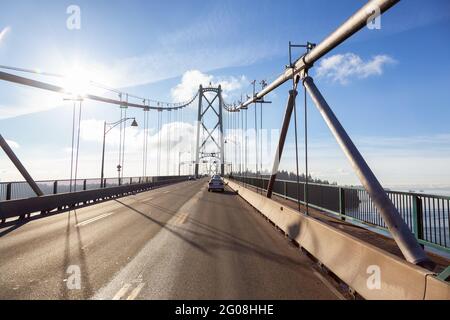 Drive across the famous Lions Gate Bridge in the modern Downtown City. Stock Photo