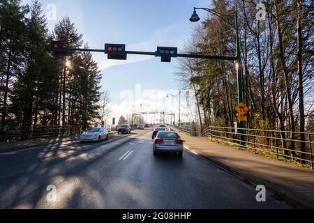 Drive across the famous Lions Gate Bridge in the modern Downtown City. Stock Photo