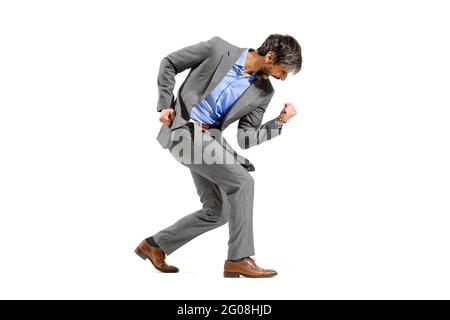 Triumphant businessman pumping the air with his clenched fists while cheering in jubilation as he strikes a winners pose isolated on white Stock Photo