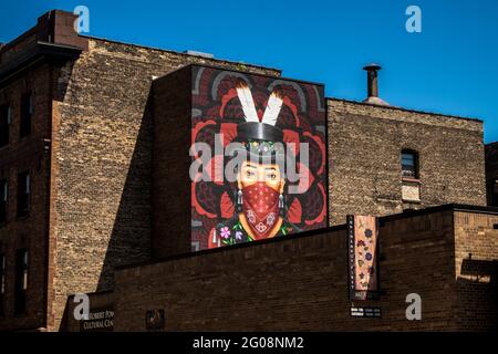 A large mural on a wall in Duluth, Minnesota, shows a Native American man wearing a face mask during the Covid-19 pandemic Stock Photo