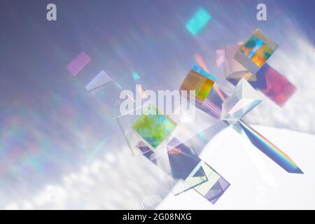 Abstract background with glass geometric figures prisms with light diffraction of spectrum colors and complex reflection. Stock Photo