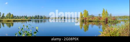 Autumnal view to a small reservoir of the Wertach river near Bobingen in bavaria Stock Photo