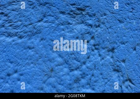 blue sculpturesque plaster with decorative indentation finish wall texture and background Stock Photo