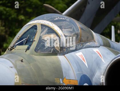 Abandoned old Buccaneer RAF fighter jet from the cold war era. Folding wings for use on aircraft carrier focus cockpit pilots seat with jet engines Stock Photo
