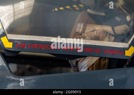 Pilots cockpit break glass in emergency to exit message on open cockpit hood of cold war fighter jet rescue. Stock Photo