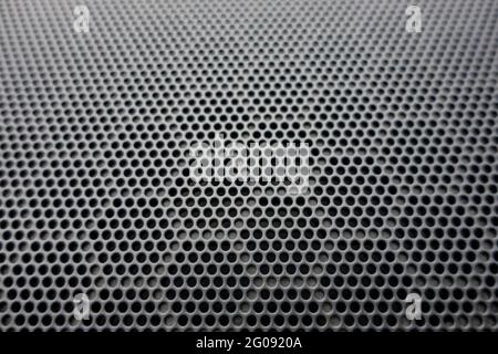Black metal texture steel radiator mesh.Gray sheet metal with holes. Geometric perforated honeycomb background. Stock Photo