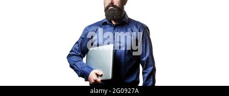 Businessman using his laptop, pc. Holding laptop computer. Serious handsome bearded man worker laptop. Bearded male businessman holding a computer in Stock Photo
