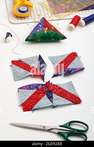 Sewing process of patchwork block, pincushion, quilting and sewing accessories. Stock Photo