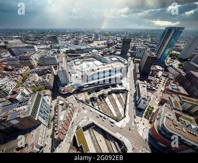 Birmingham City Centre, UK Panoramic drone aerial view of Birmingham City New Street train station from above rainbow storm clouds. Crossroads trains Stock Photo
