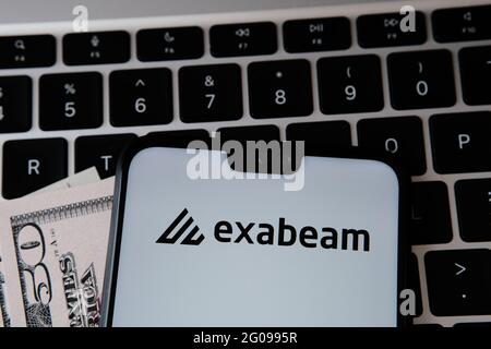 Exabeam security company logo seen on the smartphone screen with blurred laptop keyboard on the background. Stafford, United Kingdom, June 2, 2021 Stock Photo