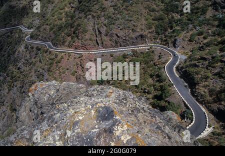 A serpent in the mountain range: The dramatic winding road into the steep valley of Masca on Tenerife island. Stock Photo