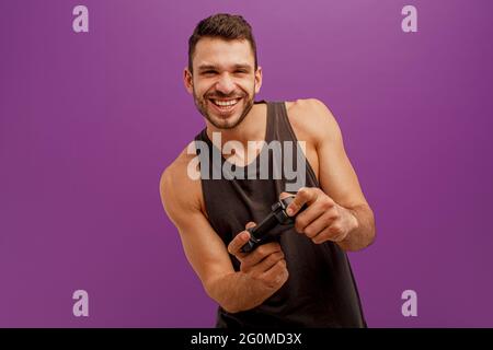 Happy european man play video game on joystick Stock Photo
