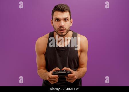 Concentrated man play video game on joystick Stock Photo