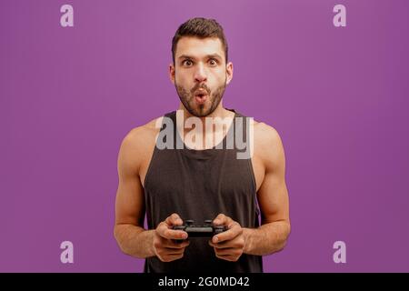 Surprised european man play video game on joystick Stock Photo
