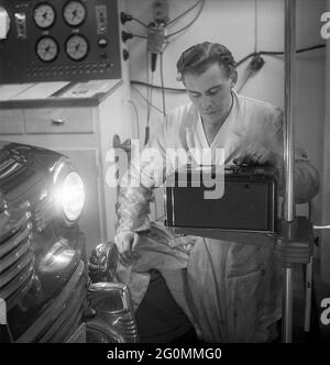 Cars in the 1950s. At this time the yearly mandatory checkup and control of cars was not in affect. Picture taken at the garage of the Swedish Royal Automobile club where a car is controlled that everything is in working order. Sweden 1951. ref BB69-3 Stock Photo