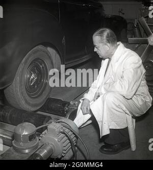 Cars in the 1950s. At this time the yearly mandatory checkup and control of cars was not in affect. Picture taken at the garage of the Swedish Royal Automobile club where a car is controlled that everything is in working order. Sweden 1951. ref BB51-8 Stock Photo