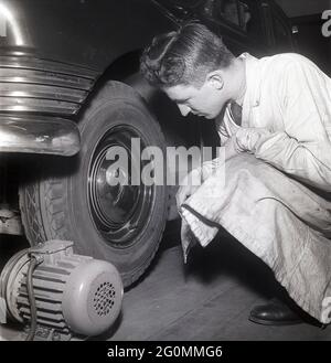 Cars in the 1950s. At this time the yearly mandatory checkup and control of cars was not in affect. Picture taken at the garage of the Swedish Royal Automobile club where a car is controlled that everything is in working order. Sweden 1951. ref BB69-10 Stock Photo