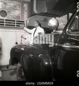 Cars in the 1950s. At this time the yearly mandatory checkup and control of cars was not in affect. Picture taken at the garage of the Swedish Royal Automobile club where a car is controlled that everything is in working order. Sweden 1951. ref BB69-4 Stock Photo