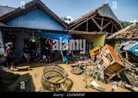 West Java, Indonesia. 2nd June, 2021. People walk through floodwaters after a flood in Bandung, West Java, Indonesia, June 2, 2021. Credit: Septianjar/Xinhua/Alamy Live News Stock Photo