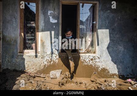 West Java, Indonesia. 2nd June, 2021. A man cleans mud from his house after a flood in Bandung, West Java, Indonesia, June 2, 2021. Credit: Septianjar/Xinhua/Alamy Live News Stock Photo