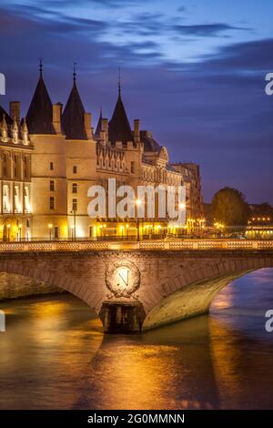 Twilight over the Conciergerie and Pont au Change along River Seine, Paris, France Stock Photo