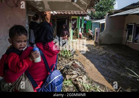 West Java, Indonesia. 2nd June, 2021. People walk on a muddy road after a flood in Bandung, West Java, Indonesia, June 2, 2021. Credit: Septianjar/Xinhua/Alamy Live News Stock Photo