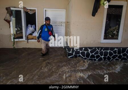 West Java, Indonesia. 2nd June, 2021. A man walks through floodwaters after a flood in Bandung, West Java, Indonesia, June 2, 2021. Credit: Septianjar/Xinhua/Alamy Live News Stock Photo