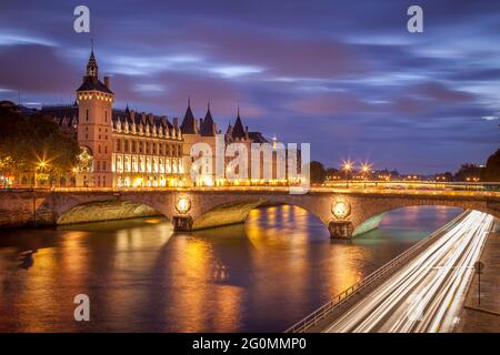 Twilight over the Conciergerie and Pont au Change along River Seine, Paris, France Stock Photo