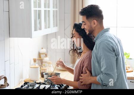Romantic Middle Eastern Spouses Preparing Food Together At Home Stock Photo