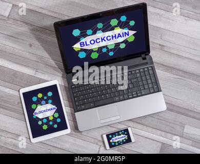 Blockchain concept shown on different information technology devices Stock Photo