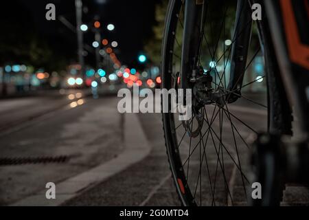 Long exposure of bicycle spokes and passing cars in at Kkralja Aleksandra boulevard in Belgrade Stock Photo