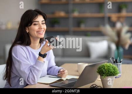 Woman using voice search assistant on cellphone Stock Photo