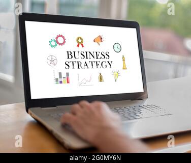 Man using a laptop with business strategy concept on the screen Stock Photo
